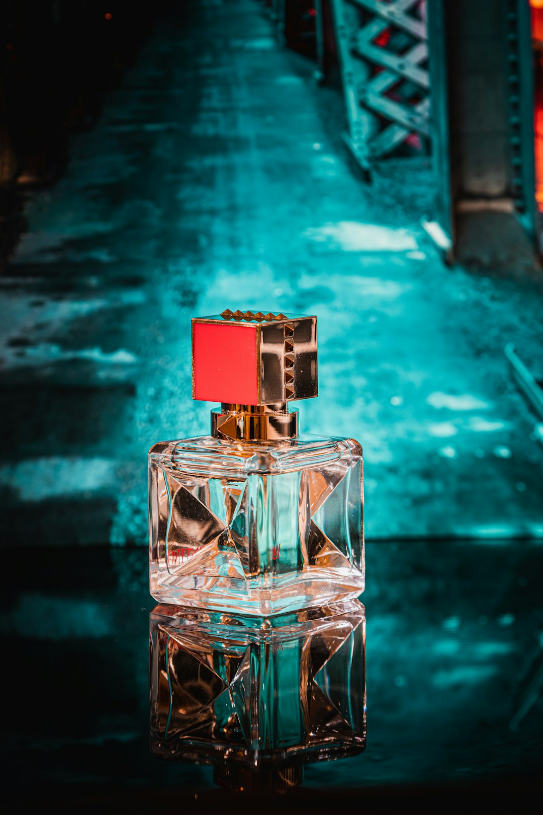 Clear glass perfume bottle against a blue background